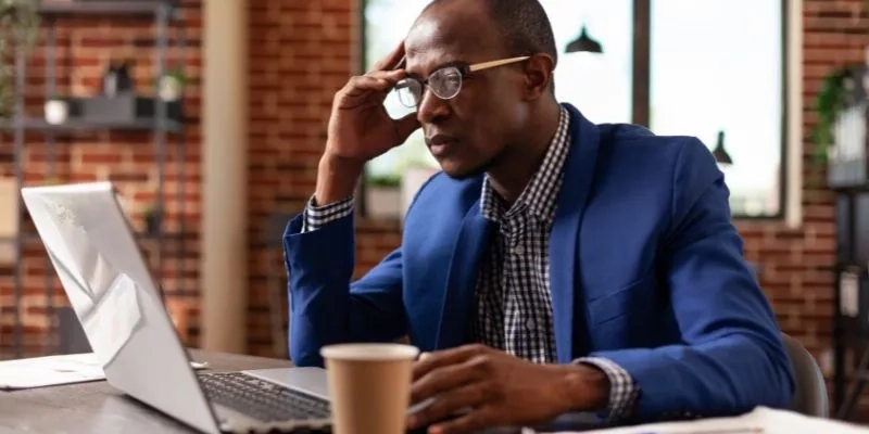 Man in Front of a Laptop Use Sensory Marketing Online to Drive Engagement With Your Customers.